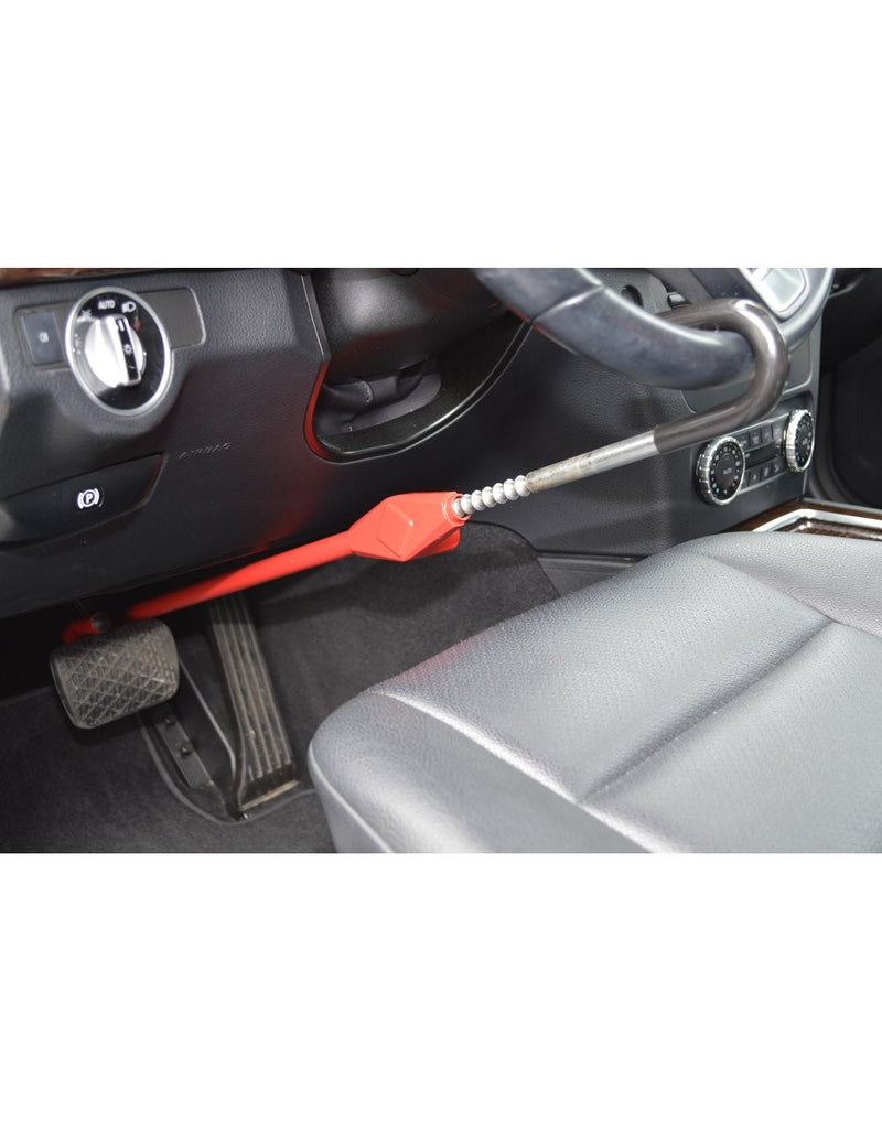 Lifestyle image of The Club® Pedal to Wheel Lock in use, one end hooked on steering wheel and other end hooked to brake pedal