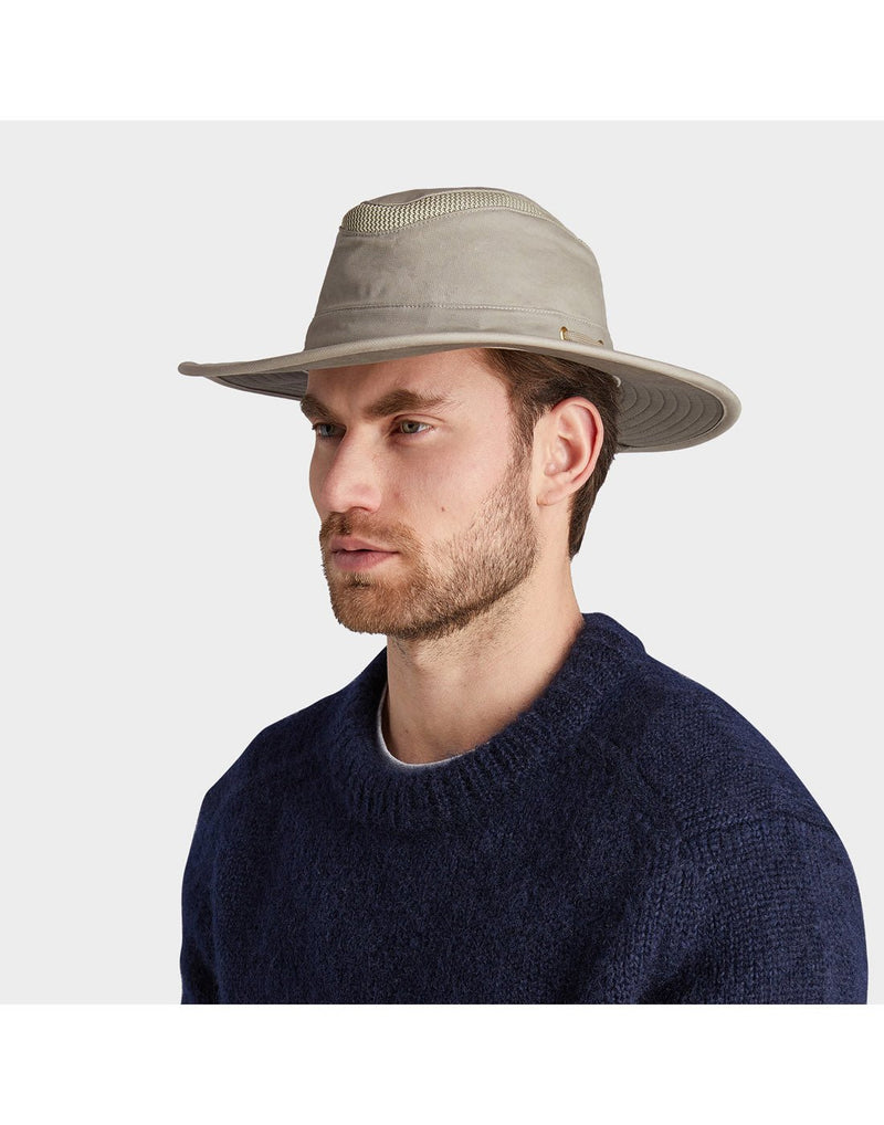 Man wearing blue sweater and the Tilley LTM6 AIRFLO® Hat in Khol, side angled view