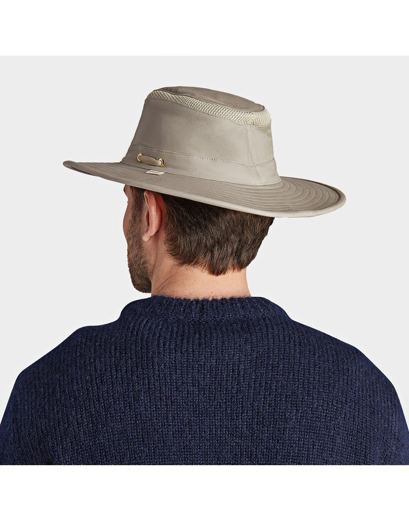 Man wearing blue sweater and the Tilley LTM6 AIRFLO® Hat in Khol, back angled view