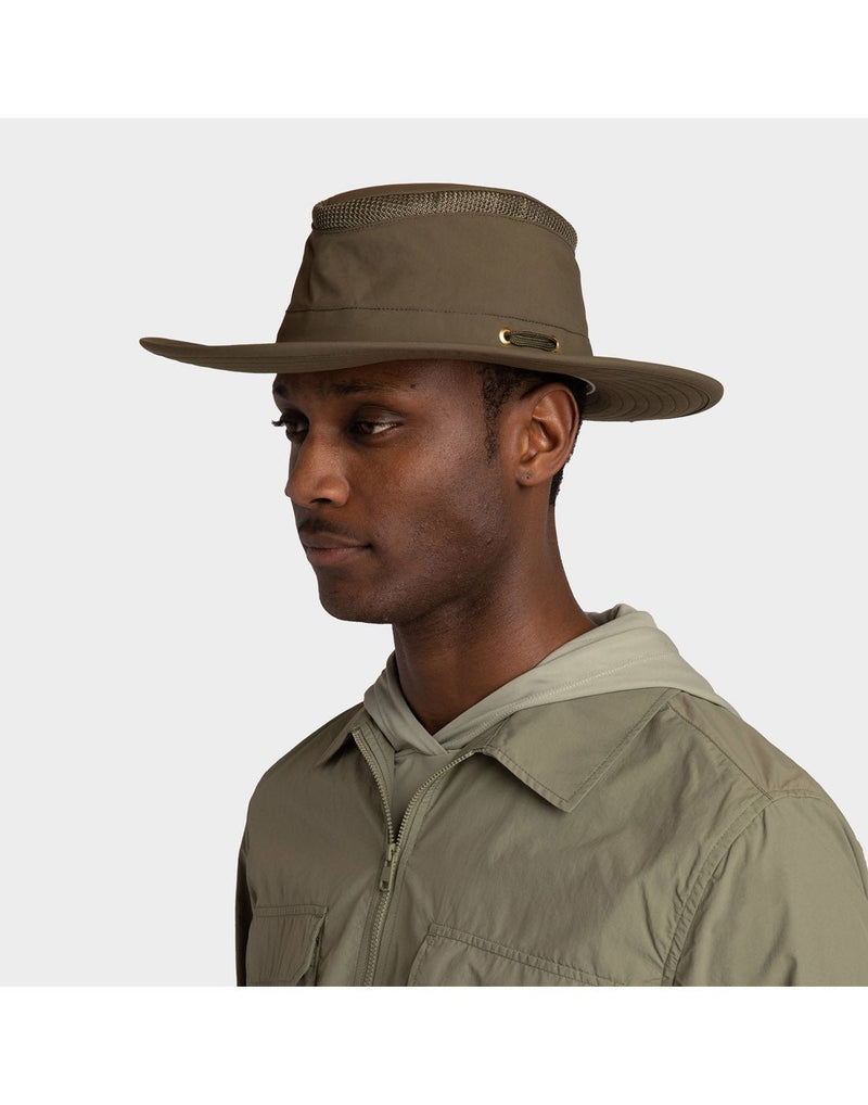 Portrait image of a man wearing khaki zip up shirt and the olive Tilley LTM6 Airflo Hat, front angled view