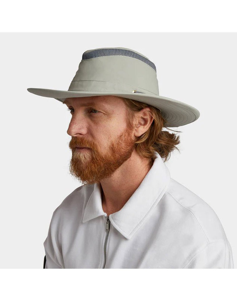 Man wearing white shirt with Tilley LTM6 AIRFLO® Hat in rockface, grey colour, side angled view