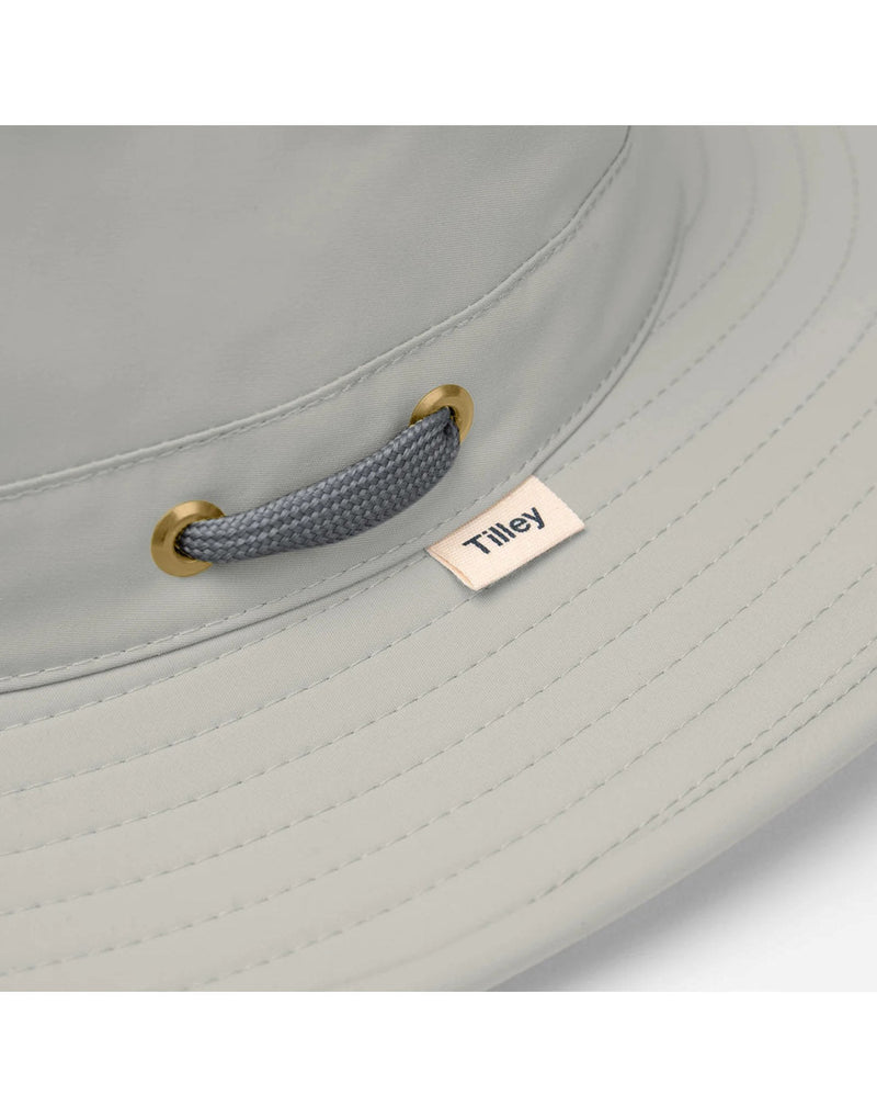 Close up of tag, eyelets, and rope of Tilley LTM6 AIRFLO® Hat in rockface, grey colour