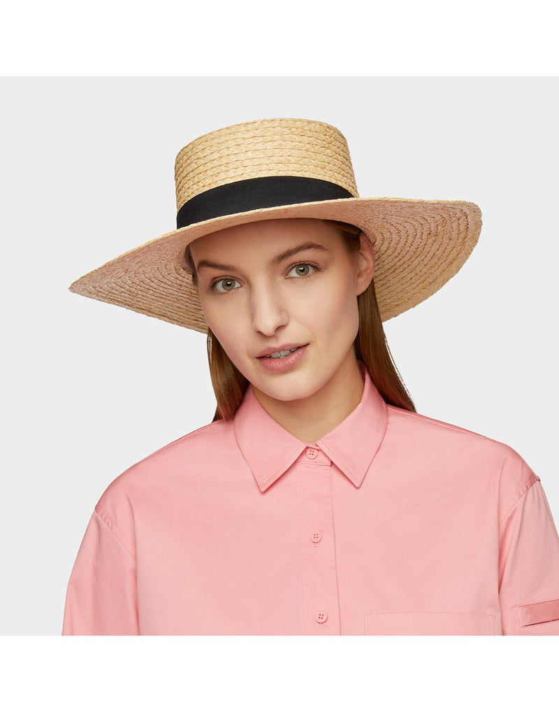 Woman wearing pink shirt and the Tilley Raffia Wide Brimmed Hat looking straight at the camera