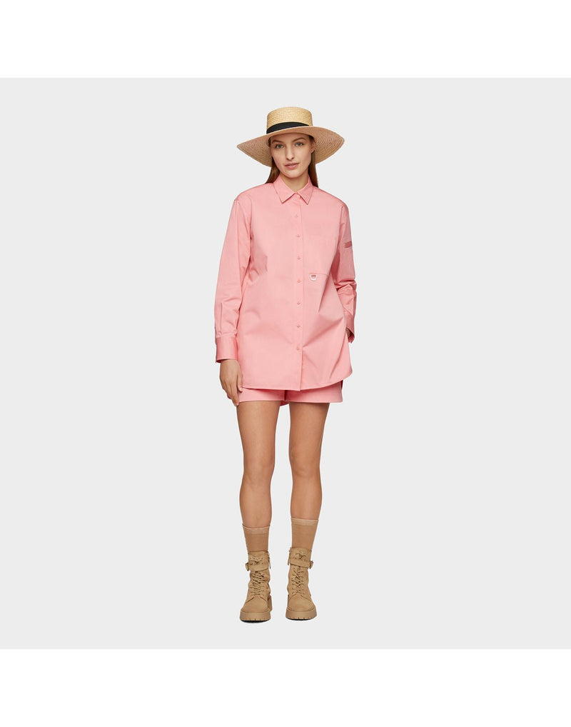 Woman wearing pink shirt and shorts and the Tilley Raffia Wide Brimmed Hat