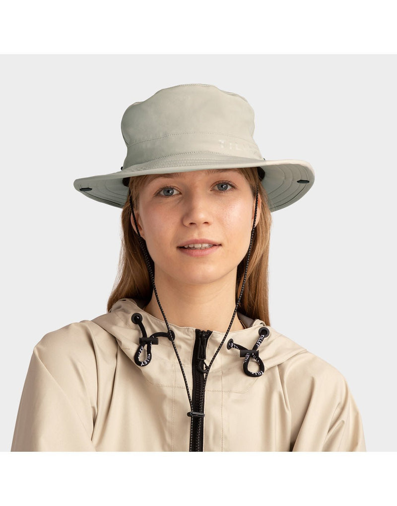 Woman wearing beige jacket and Tilley Rain Hat in stone, front view