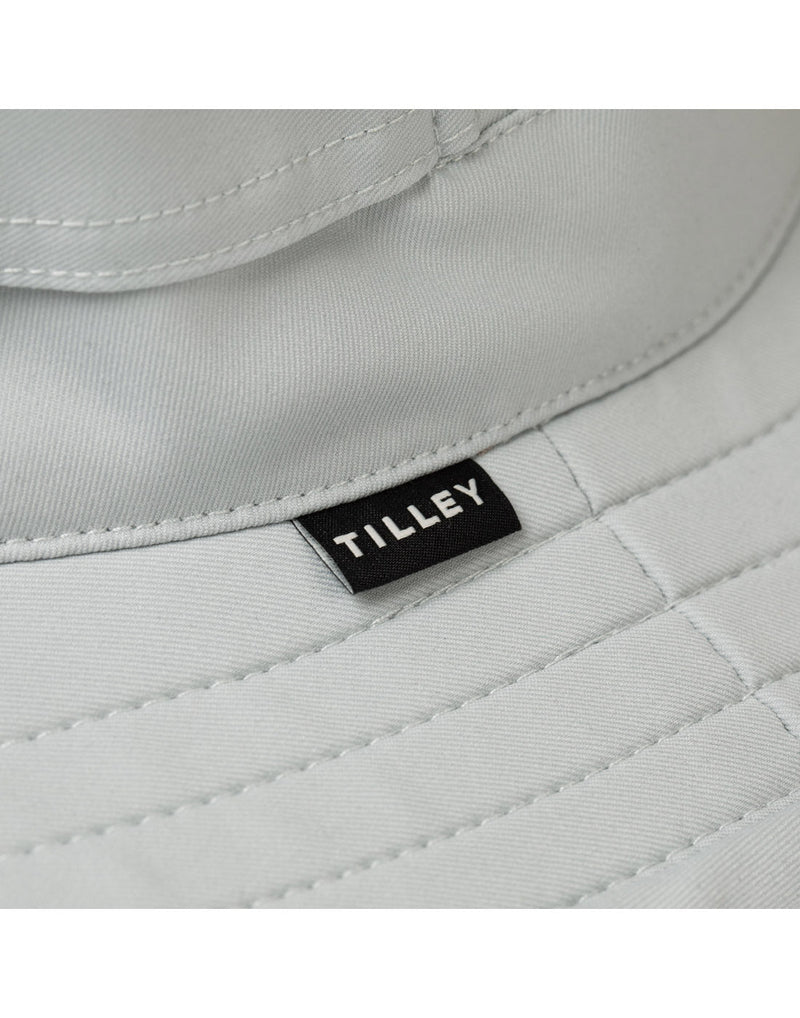 Close up of Tilley tag on outer brim of The Clubhouse Hat in light grey