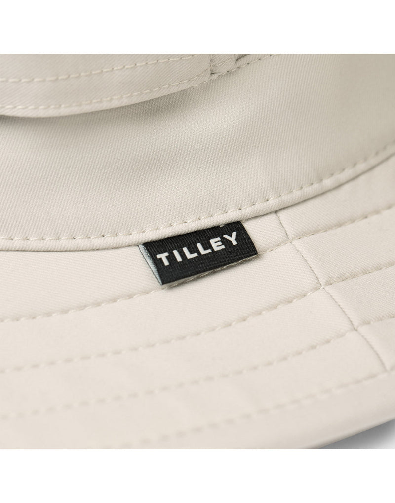 Close up of Tilley tag on outer brim of The Clubhouse Hat in lightest tan